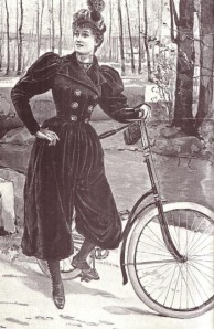 Bicyclist wearing practical bloomers. (Still looks like she's wearing a corset though.)